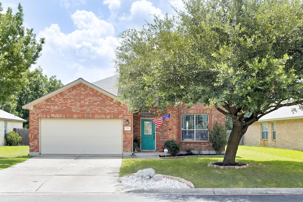 View of front of home featuring a garage, concret