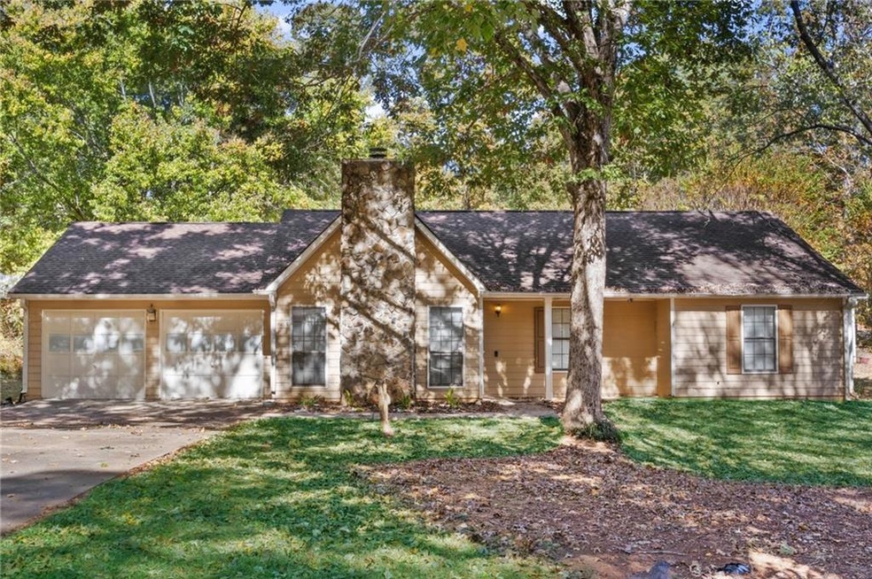 View of front facade with a garage and a front law