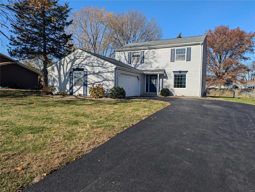 Front of property featuring a garage and a front lawn