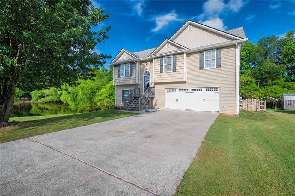 Bi-level home featuring a front yard and a garage