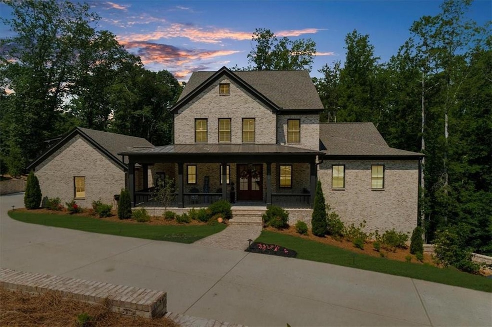 View of front facade featuring a porch and brick siding