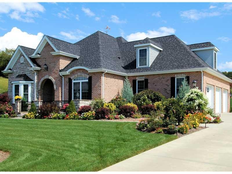 Exterior Front. Vibrant landscaping and classic ar
