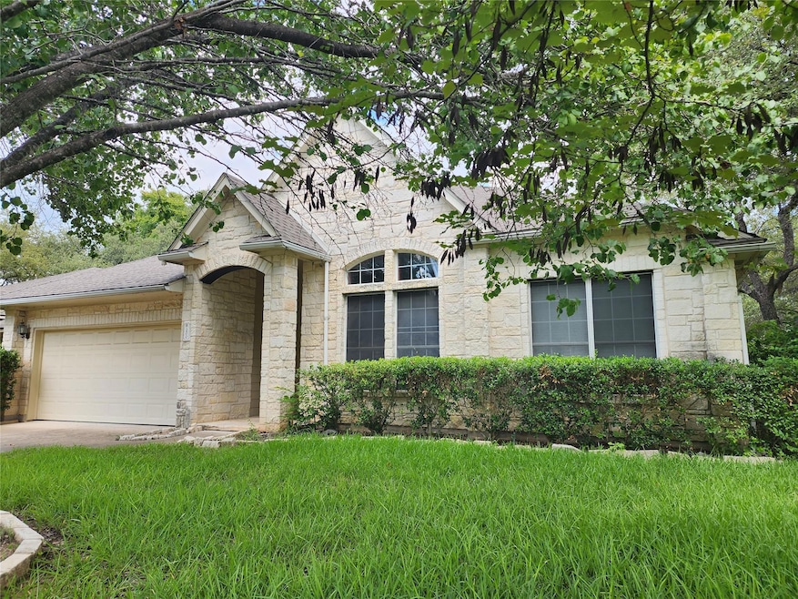 View of front of house with stone siding, a garag