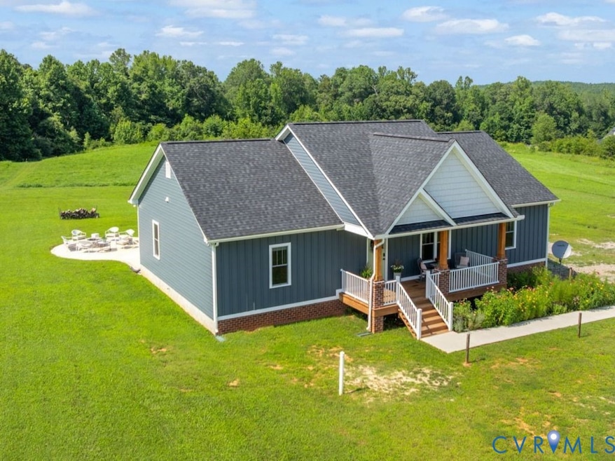 View of front facade featuring board and batten siding, roof with shingles, a porch, and a front lawn