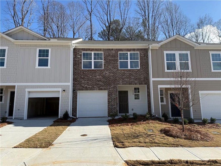 Multi unit property featuring board and batten siding, concrete driveway, and a garage