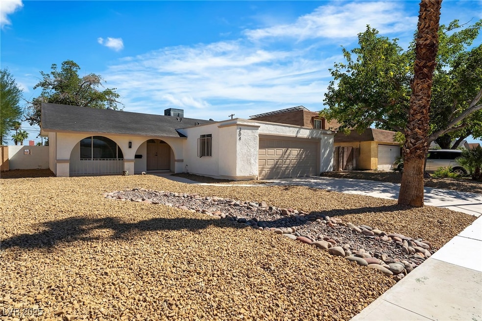 Single story home with a garage, stucco siding, and driveway
