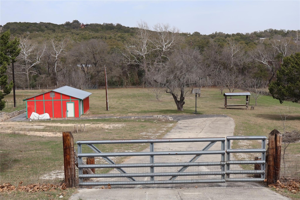 View of gate featuring an outdoor structure, fenc