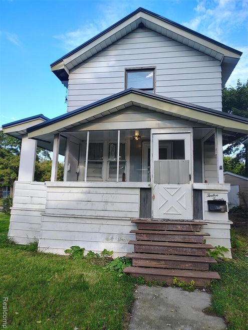 View of front of property with a front lawn and a porch