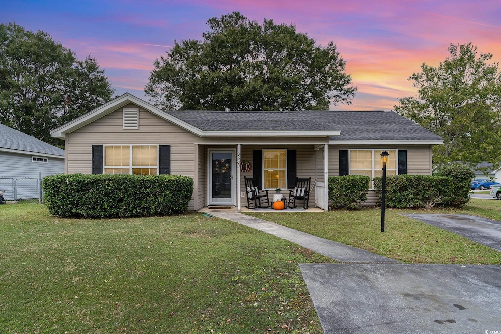 Ranch-style home featuring a lawn and a porch