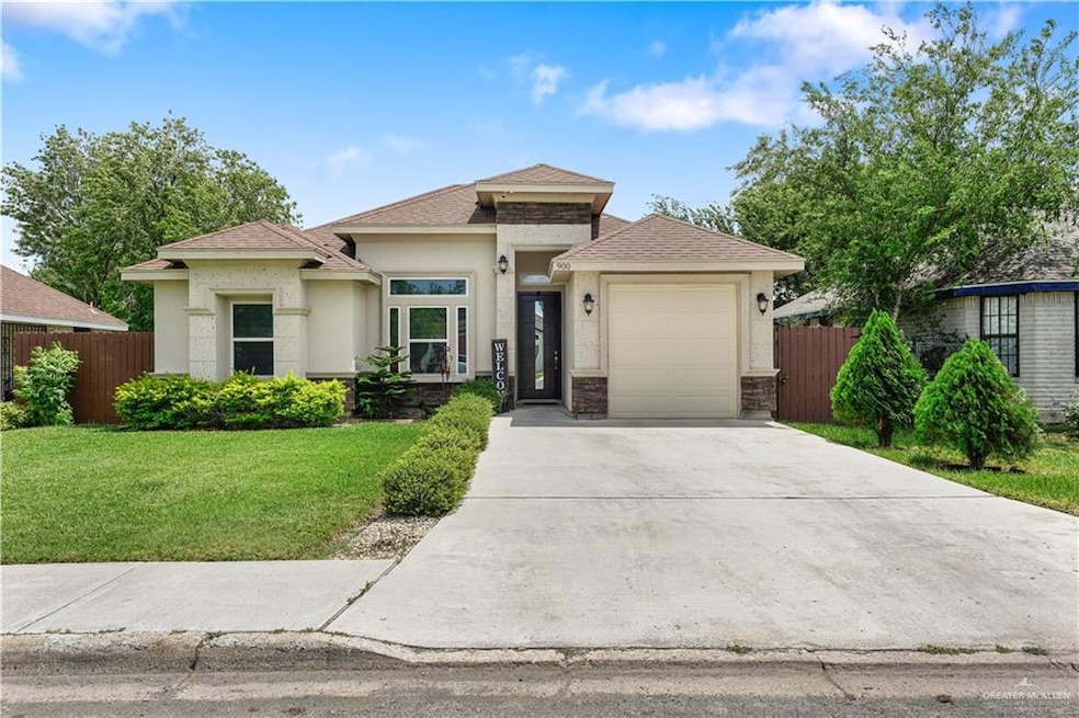 Prairie-style home featuring concrete driveway, stucco siding, an attached garage, and a shingled roof