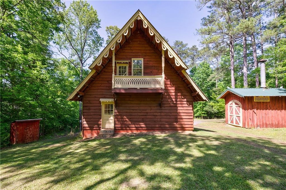 Rear view of house with a storage shed, a yard, an
