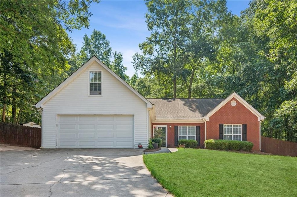 Traditional-style house featuring driveway, a garage, and brick siding