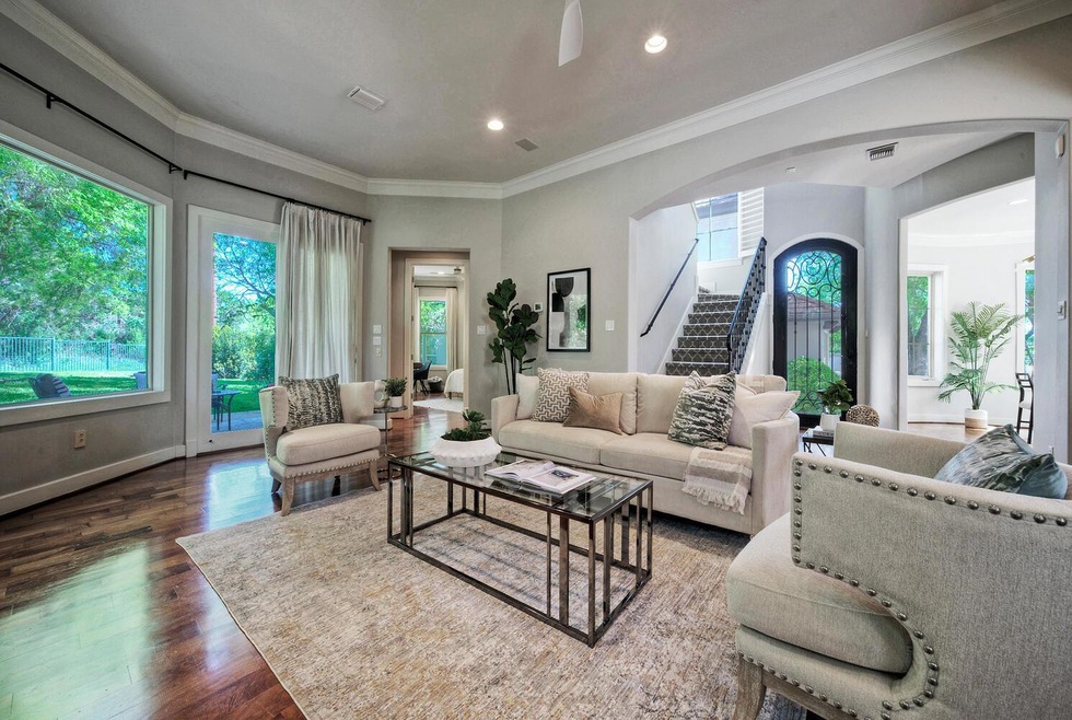 Living room featuring arched walkways, stairway, 