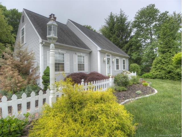 A charming brick walkway behind the picket fence l