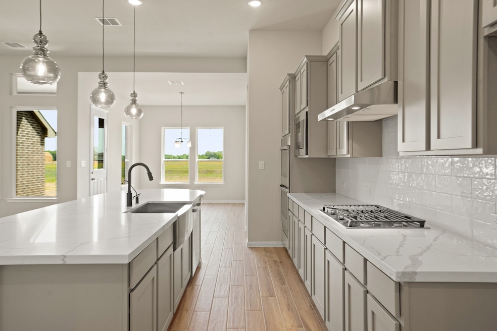 Lovely quartz countertops and stainless appliances