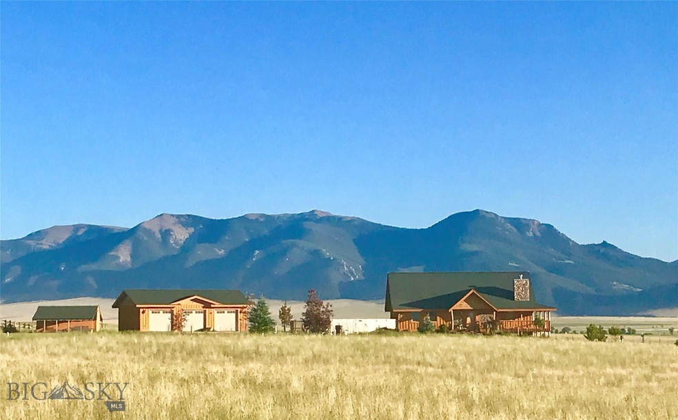 View of home, 3 car garage, storage building looki