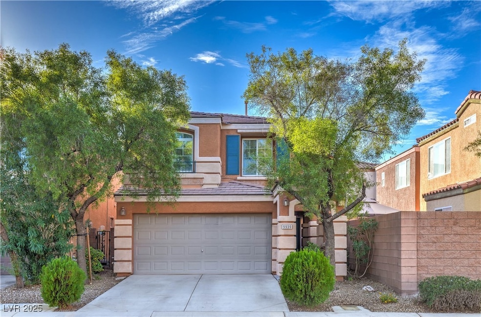 View of front facade with an attached garage, stucco siding, driveway, and a tile roof