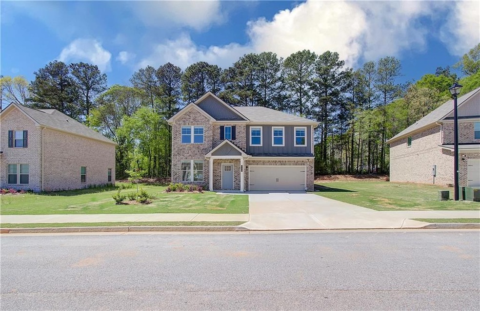 View of front facade with a garage and a front law