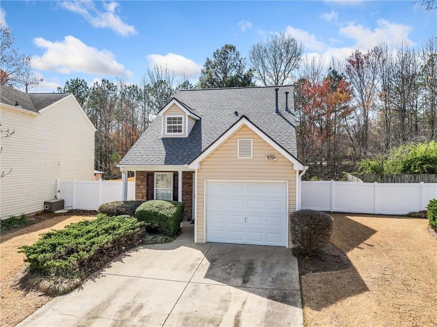 View of front of home featuring concrete driveway,