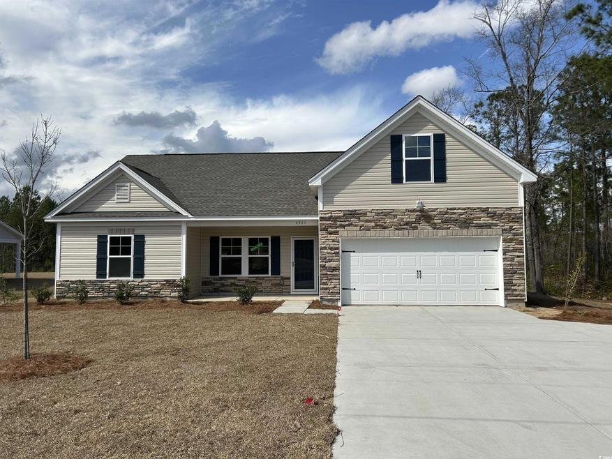 Craftsman house with an attached garage, driveway,