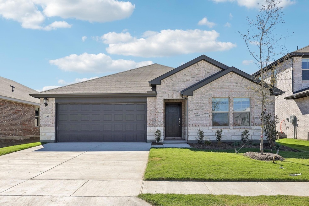 View of front facade with a garage and a front law