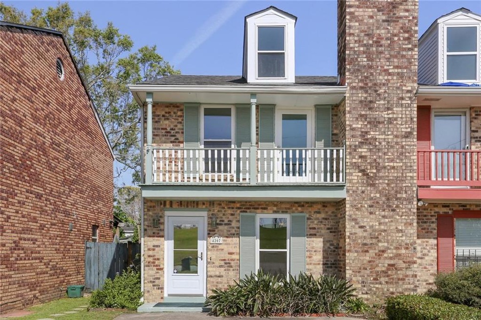 Nice brick townhouse with upper balcony that overl