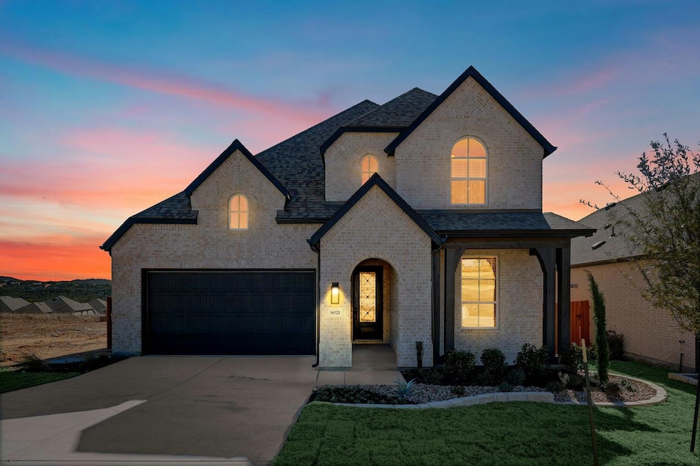 French country style house featuring brick siding