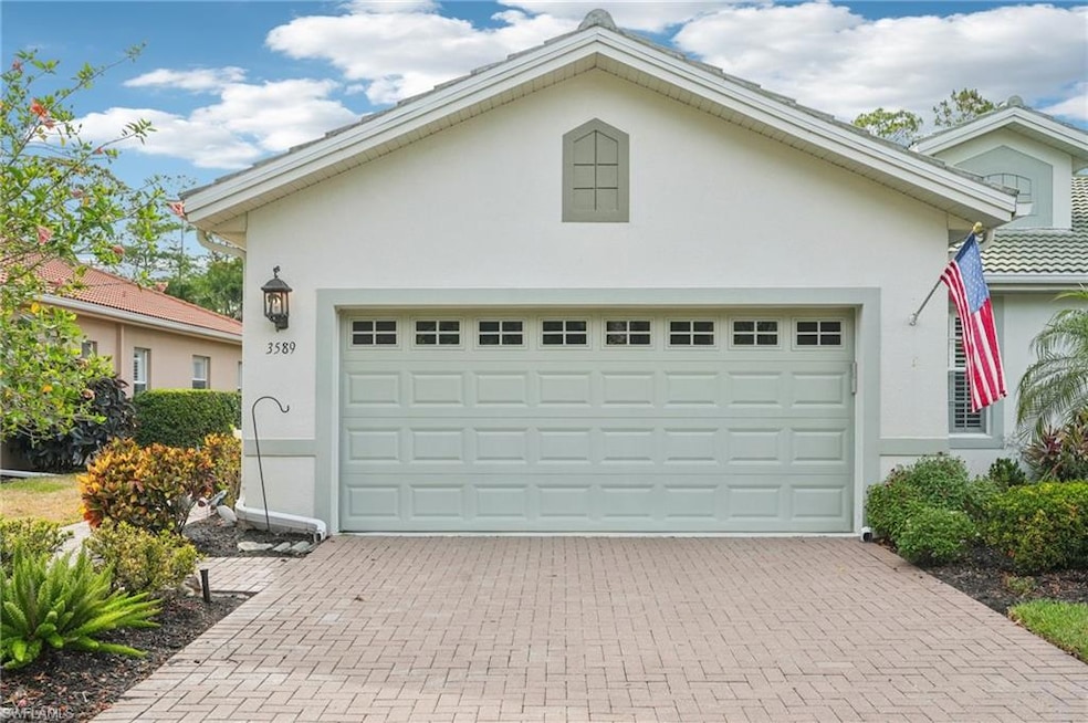 Garage featuring decorative driveway