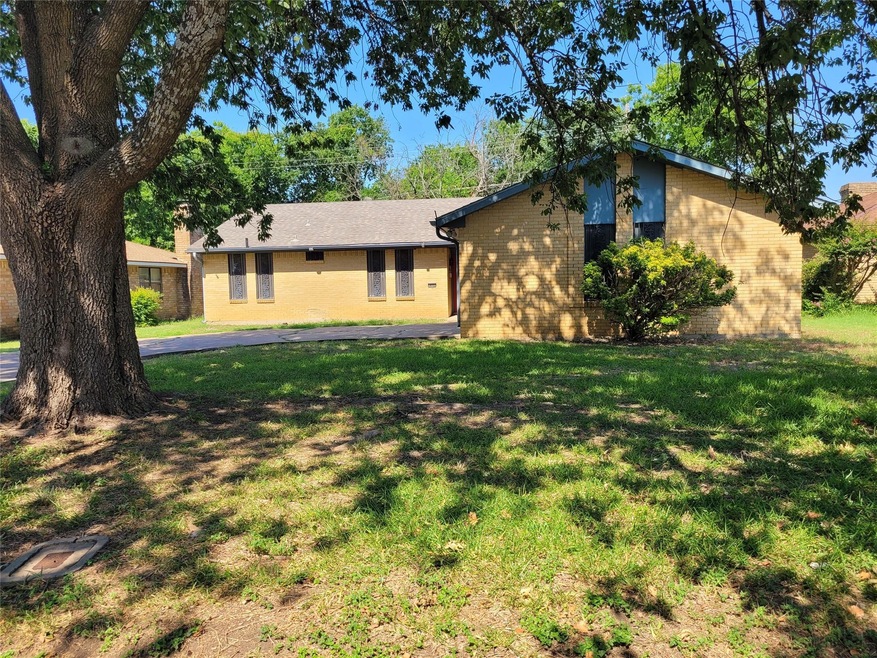 View of front of home with a front yard and shade 
