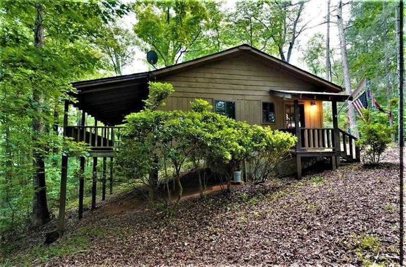 The cabin has a large, covered back porch, overloo