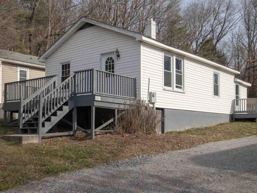 The front view of the home features a spacious dec