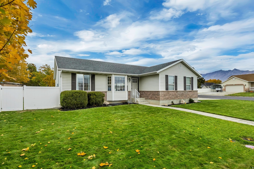 View of front of property featuring brick siding, a mountain view, and roof with shingles