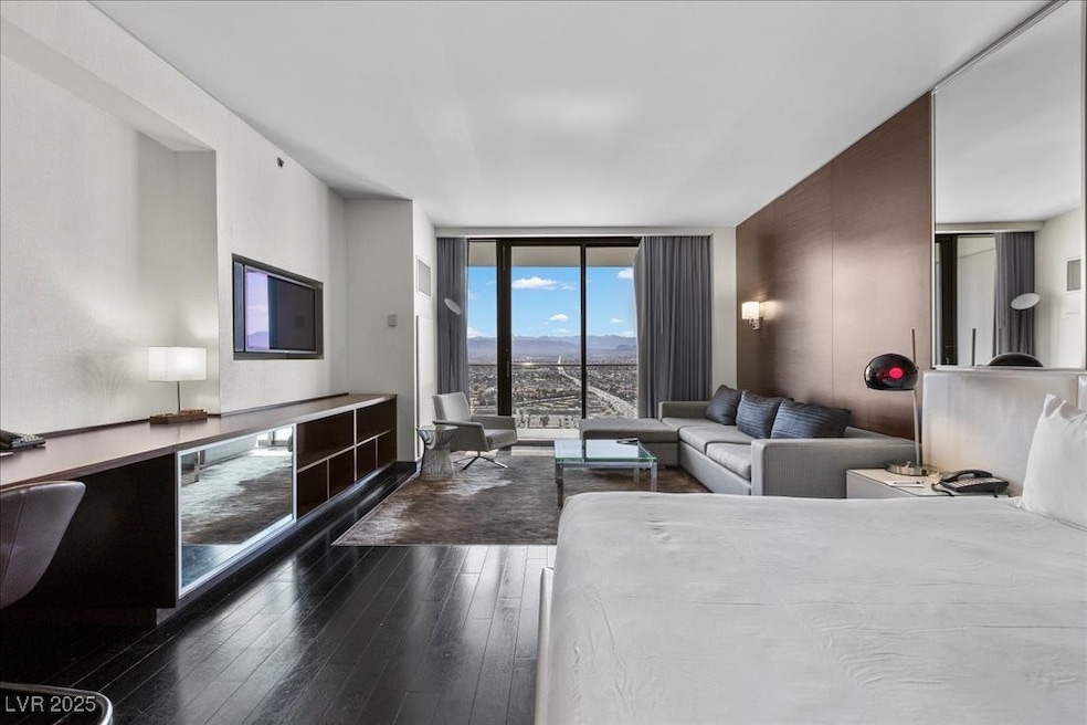 Living room featuring a wall of windows and dark w