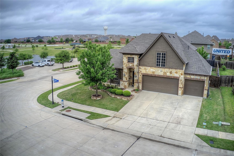 Premium Corner Lot With Custom Stone Elevation And Three Car Garage. The Covered Front Porch Offers Beautiful Water And Park Views.a garage