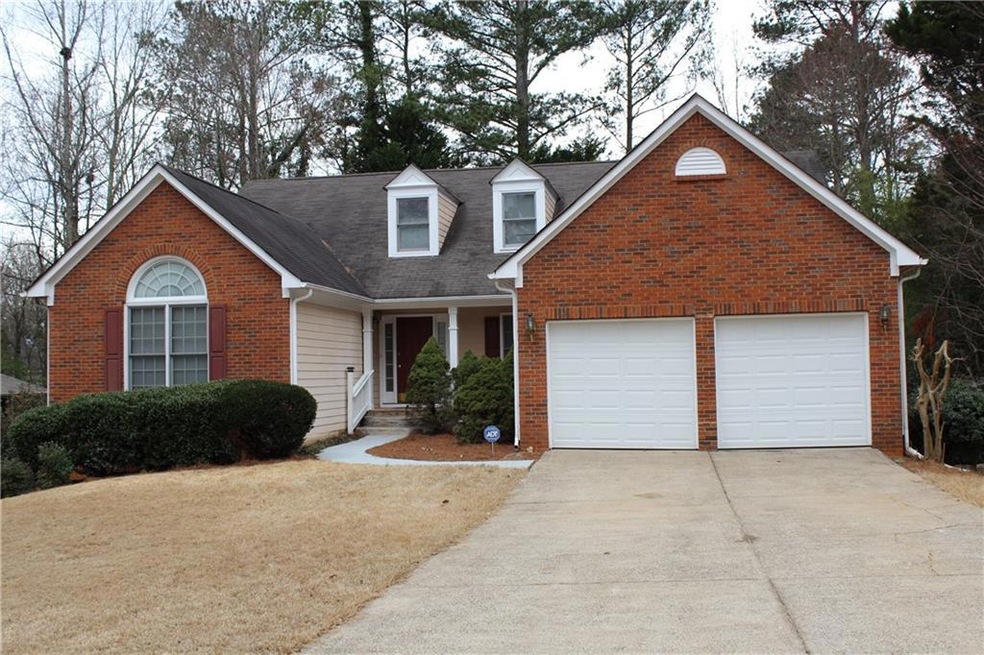 View of front of property with a garage and covere