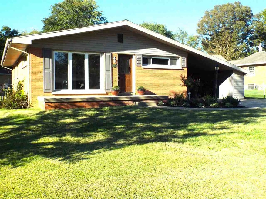 All brick ranch with 3 car attached Tandem garage 