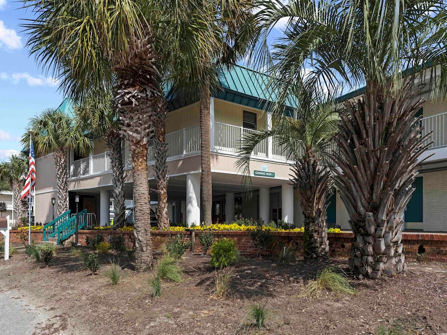 View of front of home featuring stucco siding, met