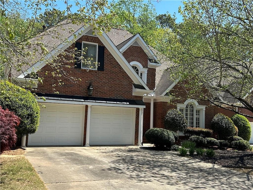 Traditional home featuring concrete driveway, a ga