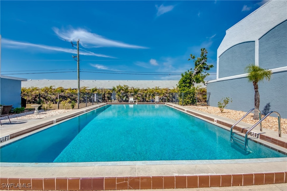 Community pool featuring fence