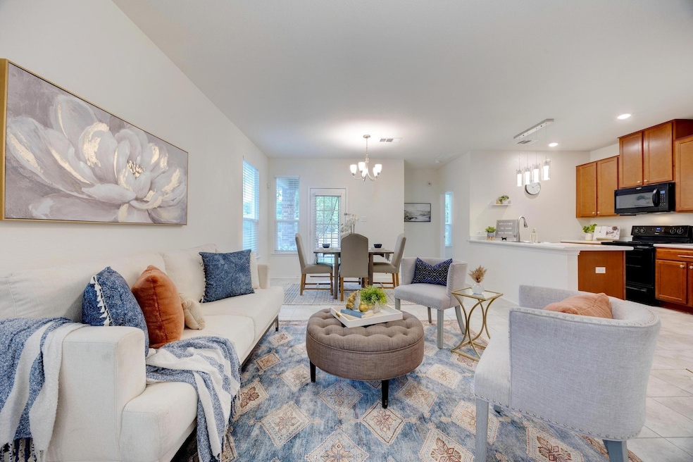 Living area with recessed lighting, a chandelier,