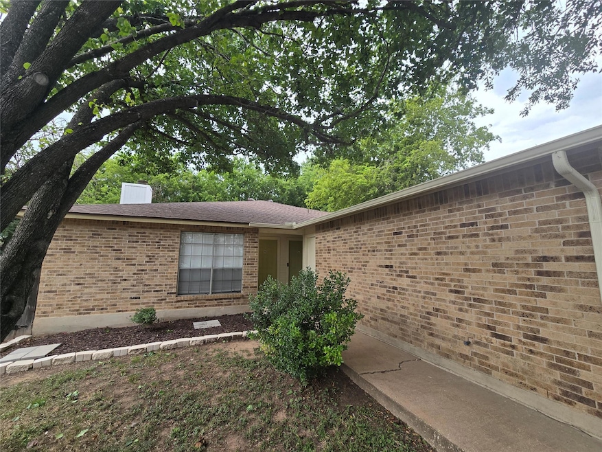 View of side of home with brick siding