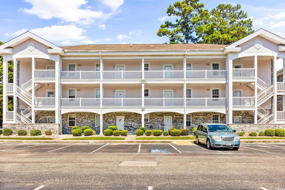 View of property featuring uncovered parking