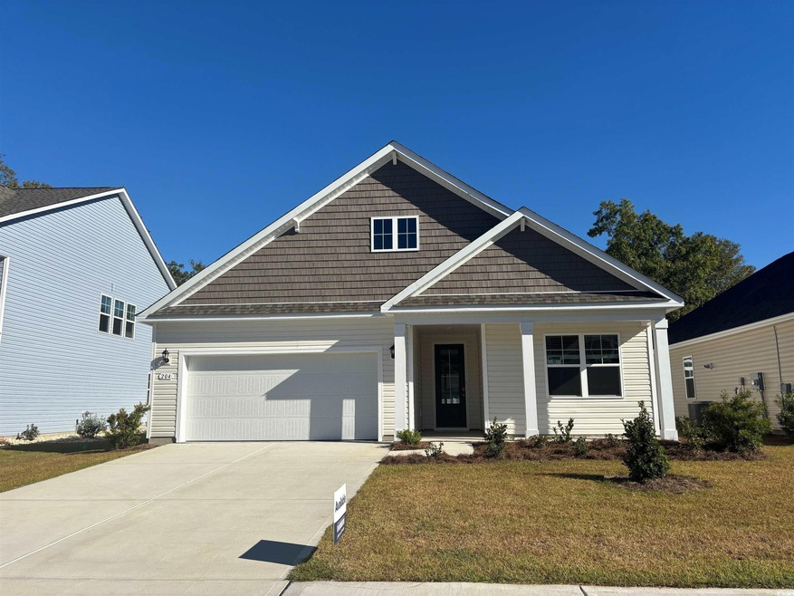 Craftsman house with a garage and a front lawn