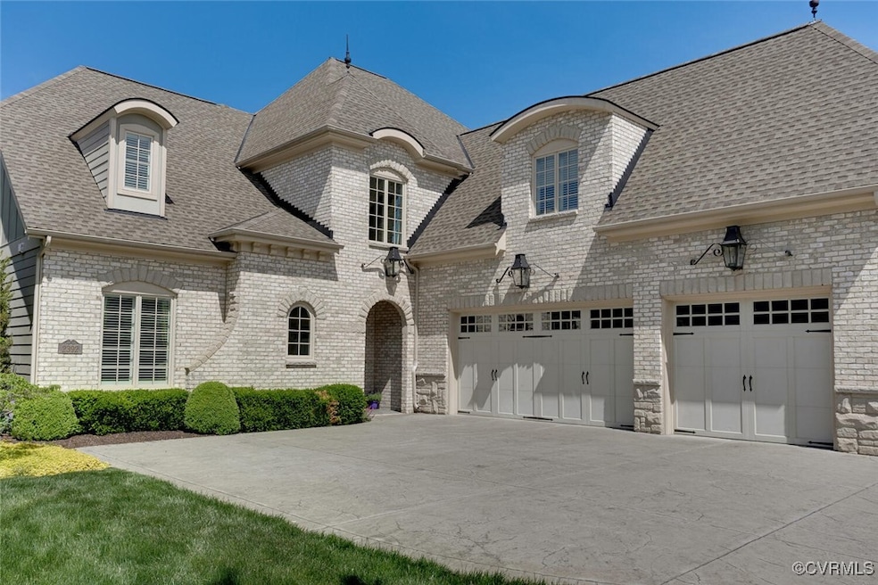 French country style house featuring concrete driv