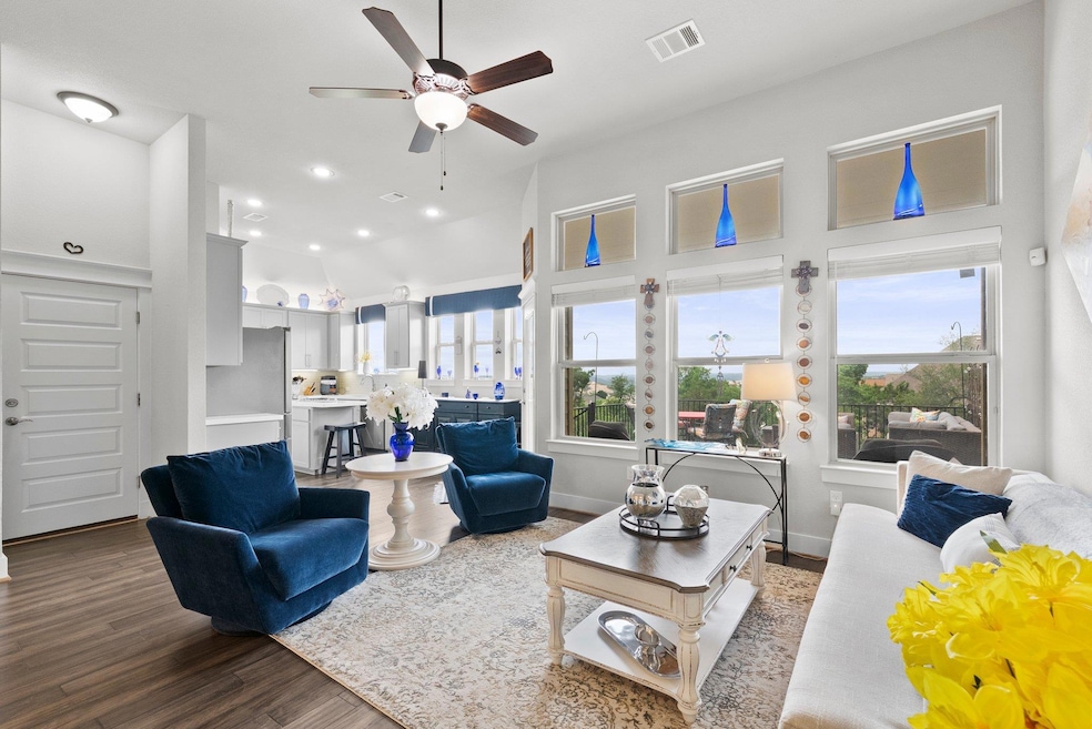 Living area featuring ceiling fan, wood finished 