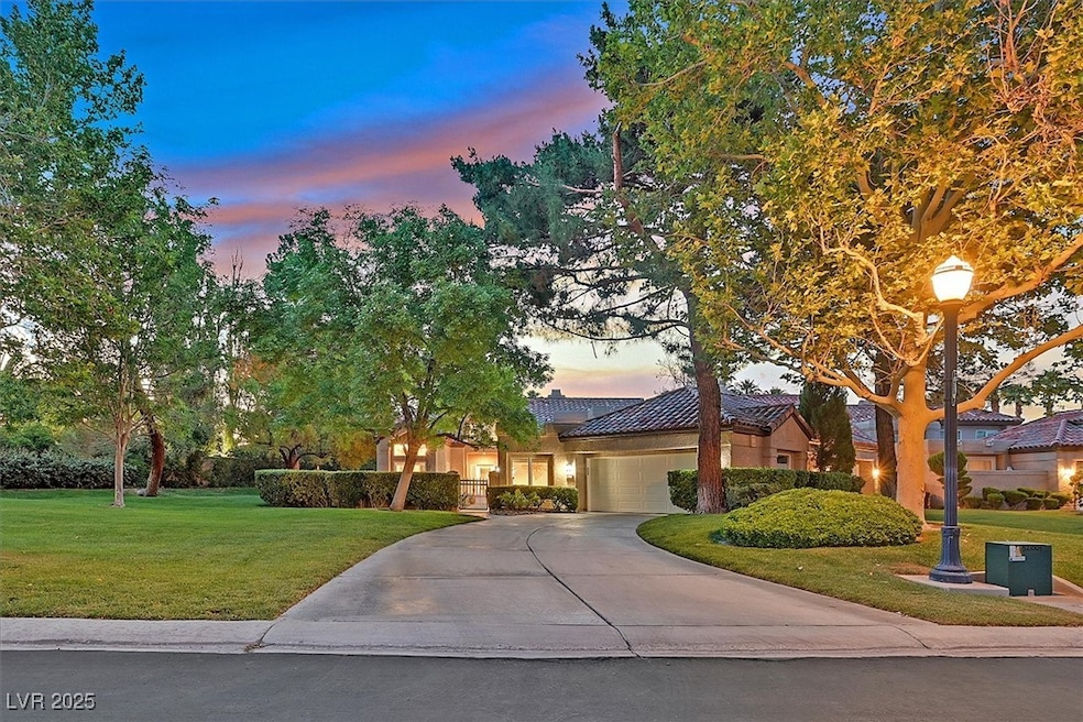 View of front of home with a garage, driveway, a f