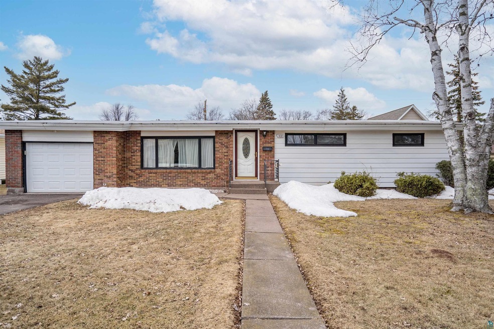 Back-top driveway leads to 1 car garage.  Great of