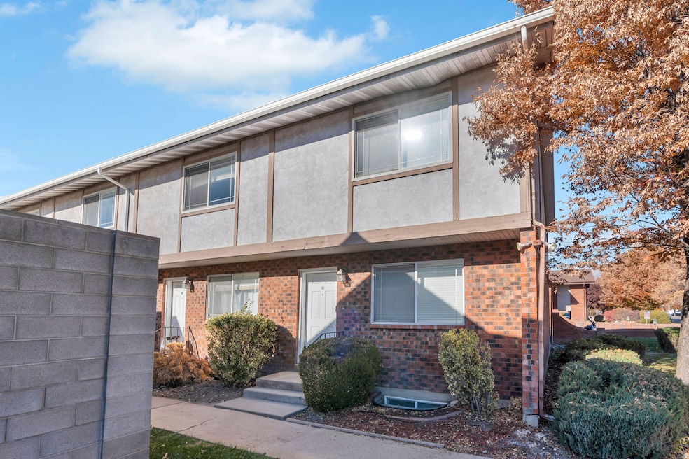 View of front of house with brick siding and stucco siding