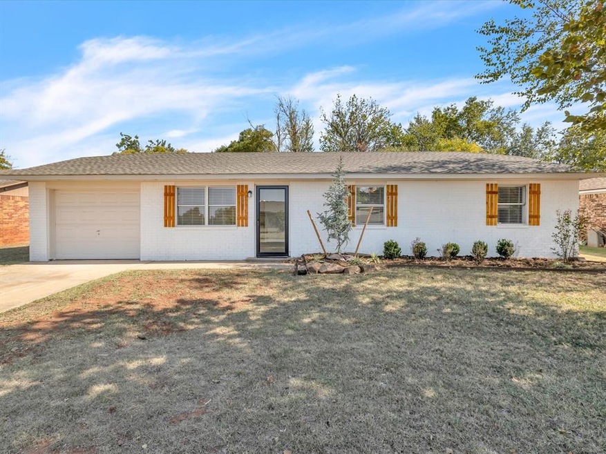 Ranch-style home with a front yard and a garage