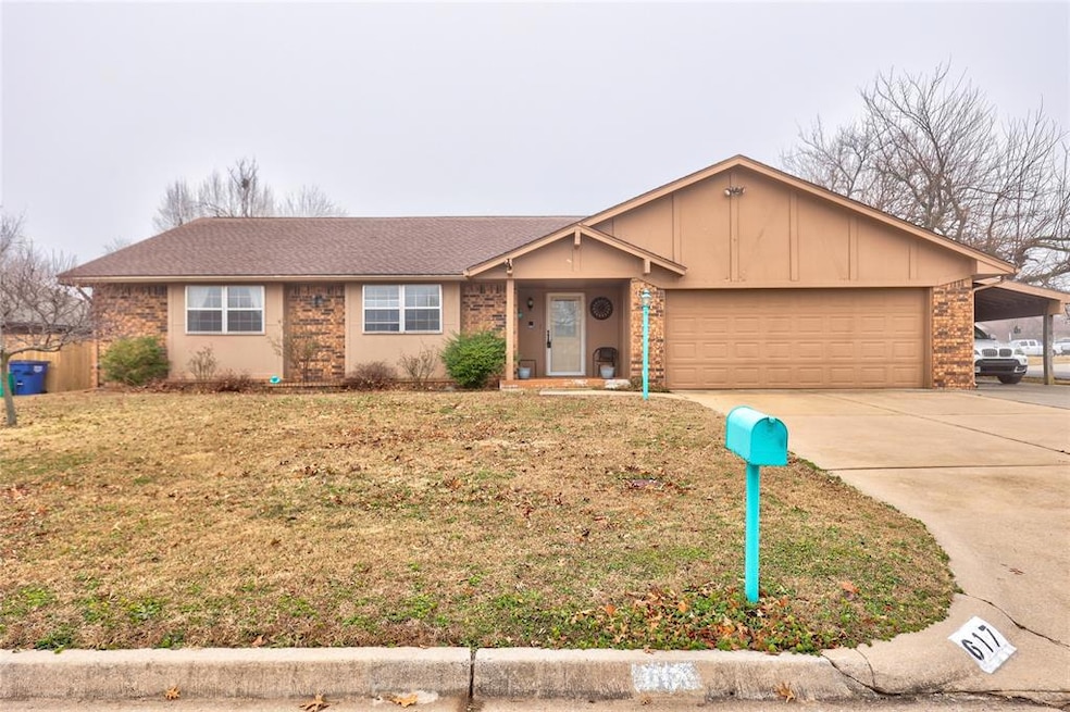 Ranch-style house with an attached garage, concrete driveway, board and batten siding, and brick siding